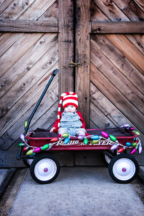 Sweet-Christmas-Baby-in-Radio-Flyer-wagon-in-Old-Poway-Park-Sayr
