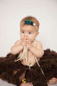 Baby Brooklyn sitting up with pearls